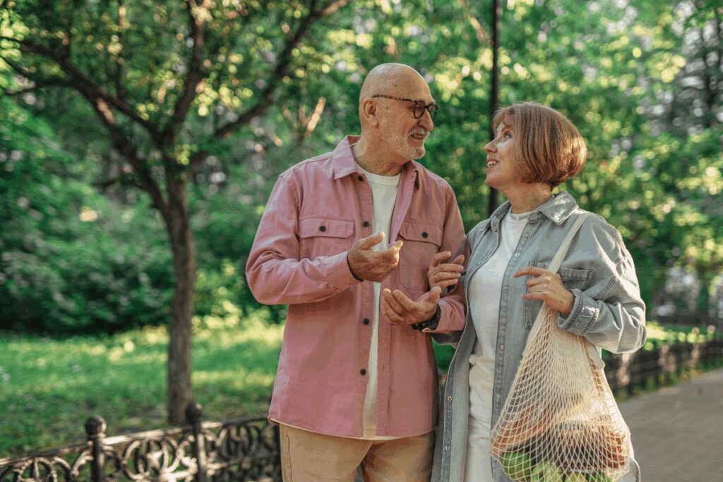 Couple discussing retirement income strategies while walking in the park