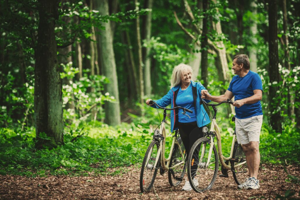 A couple taking a ride in the woods after doing their retirement tax planning
