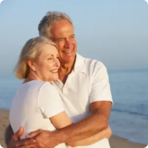 Couple on Beach watching the sunset from the sun's POV